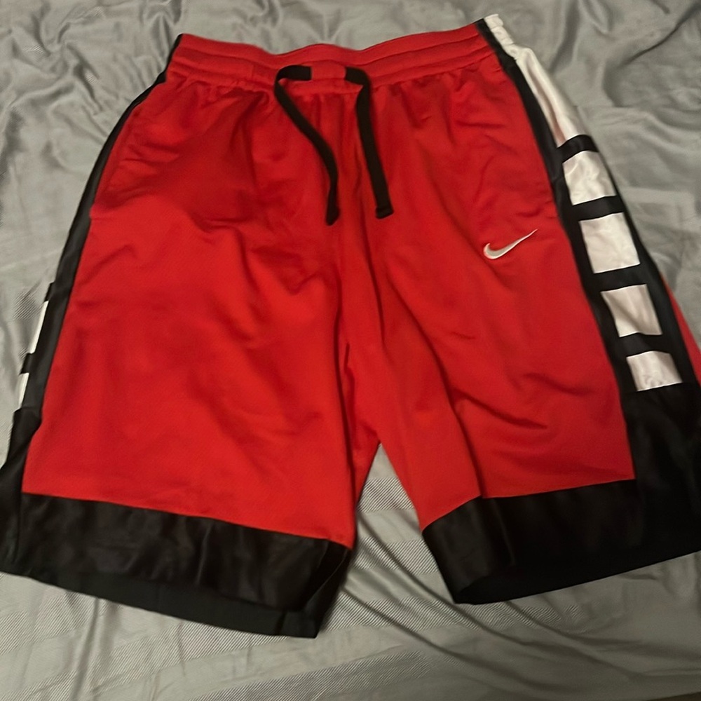 Nike dri fit red shorts over worn